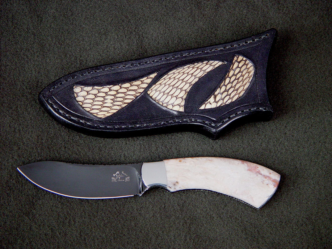 "El Tanin" obverse side view in mirror polished, hot blued O1 high carbon tungsten-vanadium tool steel blade, 304 stainless steel bolsters, White Petrified Wood gemstone handle, Cobra skin inlaid in hand-carved leather sheath
