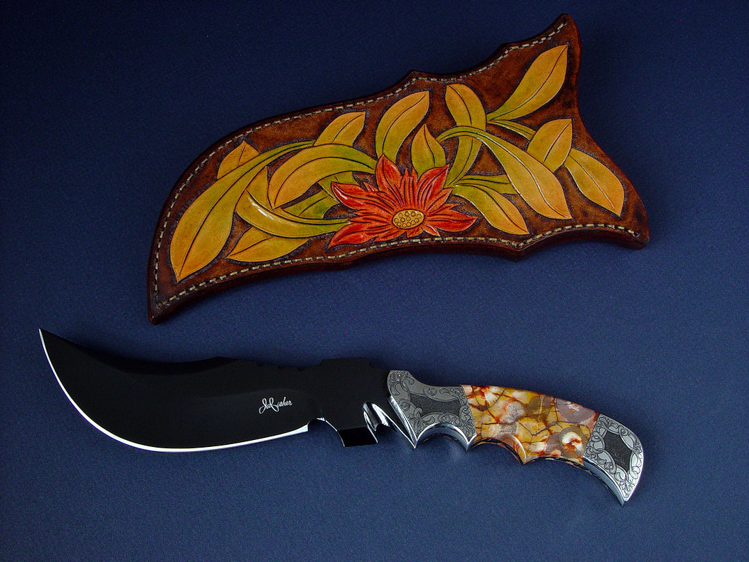 "Flamesteed" obverse side view in mirror finished, hot blued O1 high carbon tungsten-vanadium tool steel blade, hand-engraved 304 stainless steel bolsters, Bird's Eye Rhyolite gemstone handle, hand-carved, hand-dyed leather sheath