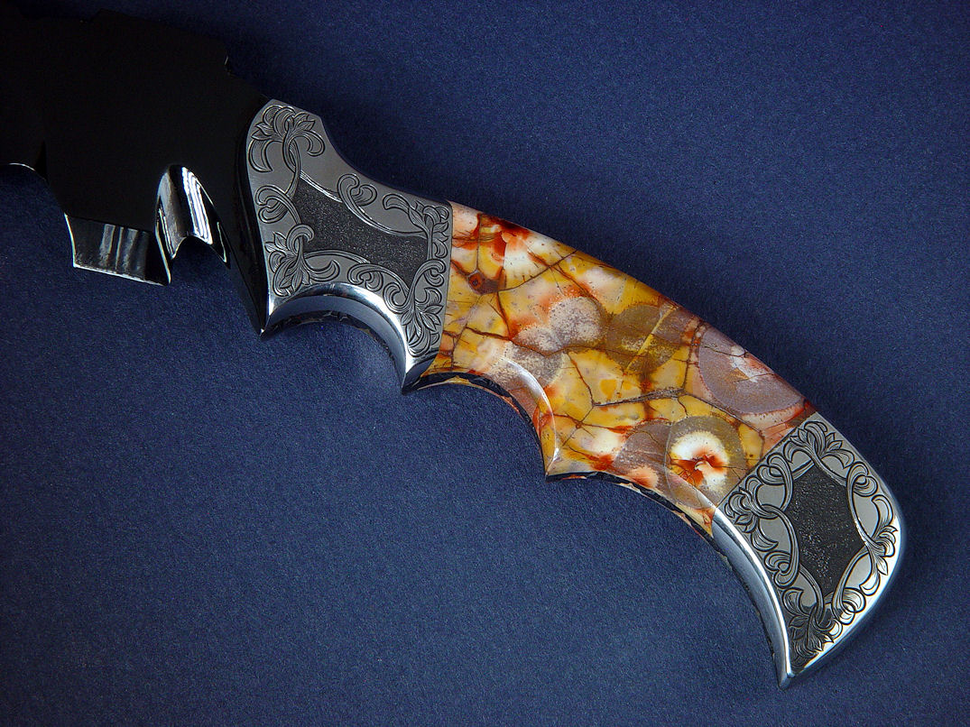 "Flamesteed" obverse side handle view. Dark blade is matched with deep relief engraving that blends pattern of stone with dark finish.