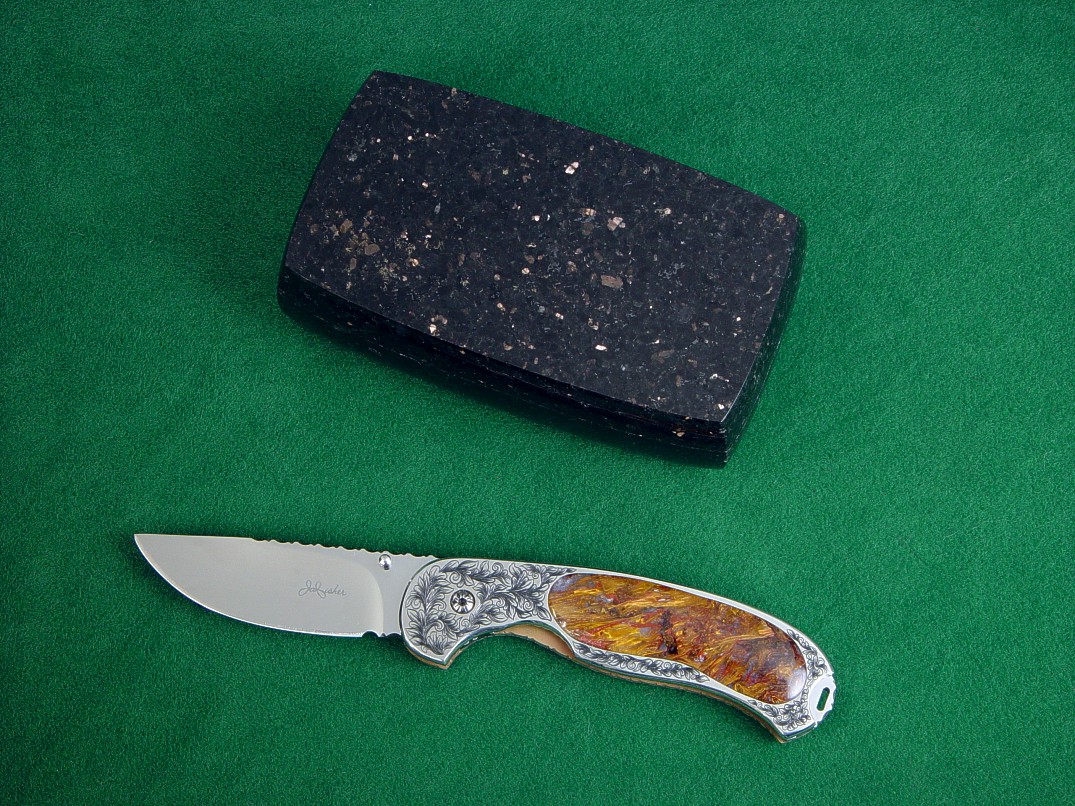 "Izar" linerlock folding knife, obverse side view in 440C high chromium stainless steel blade, hand-engraved 304 stainless steel liners, 6AL4V anodized titanium lockplate, Pietersite Agate gemstone handle, Black Galaxy Granite gemstone case lined with leather 