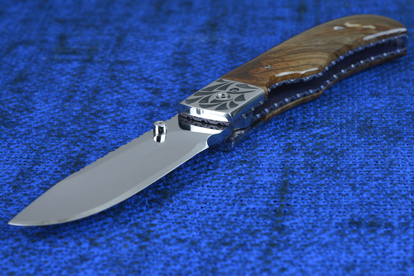 "Sadr" linerlock folding knife, handle detail showing anodized and fileworked titanium liners and front bolster and pivot detail