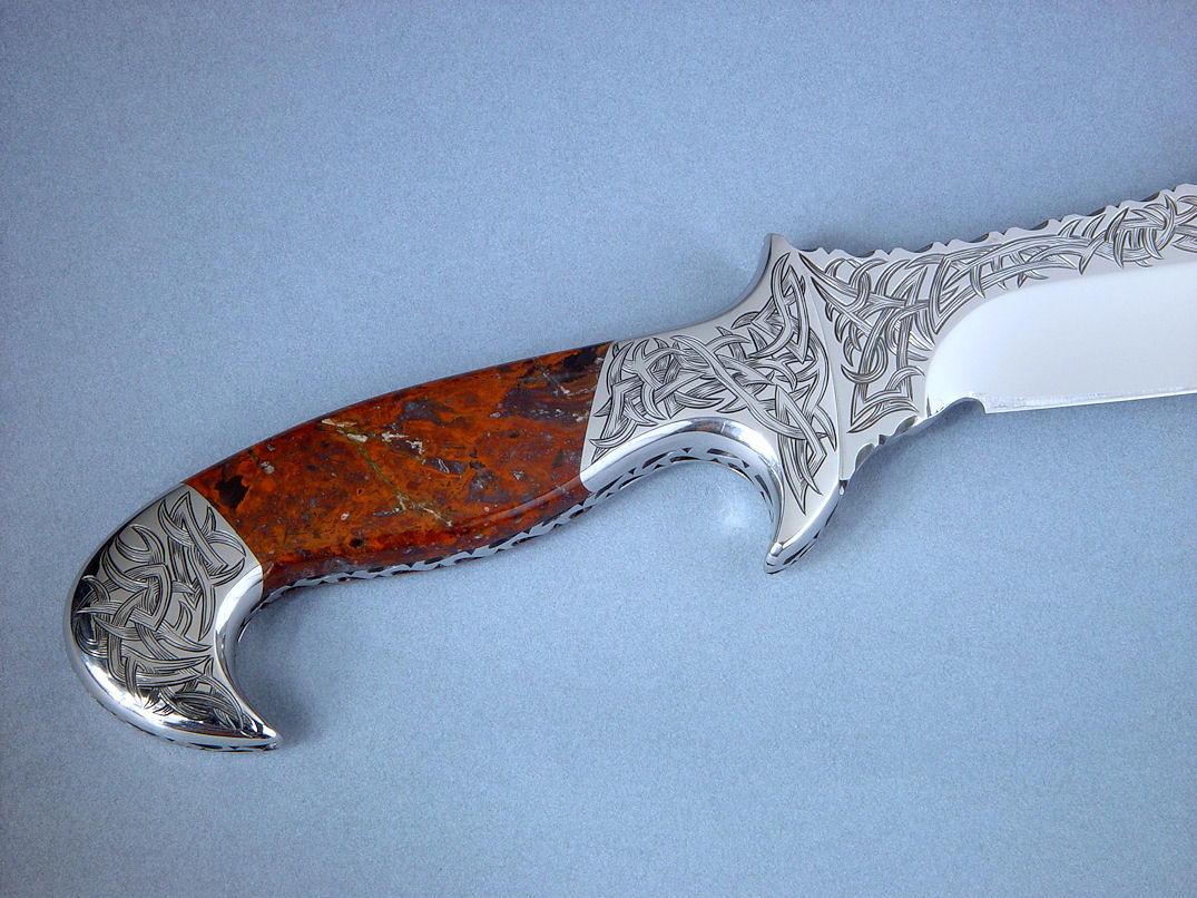 "Tribal" (Helhor pattern) reverse side handle, engraving view. Tribal engraving pattern is dominant throughout knife, sheath, and sculptural display stand