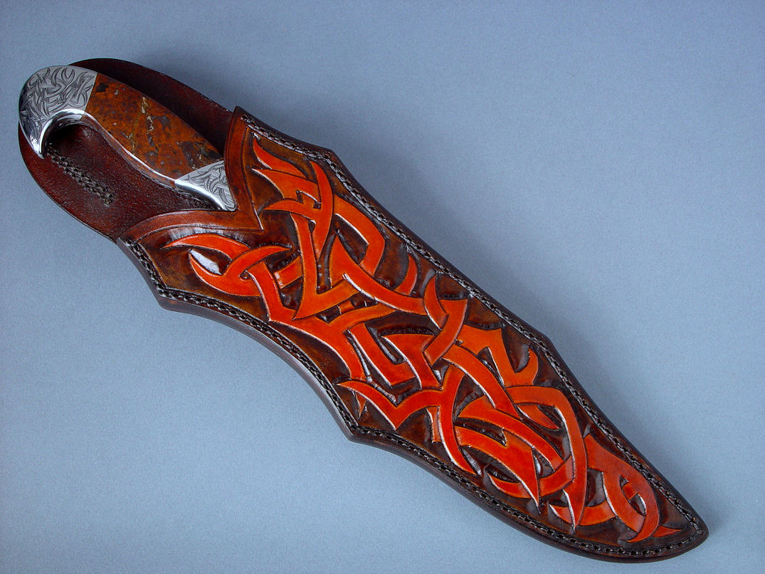 "Tribal" (Helhor pattern) sheathed view. Sheath is hand-carved, hand-dyed leather shoulder, hand-stitched with nylon 
