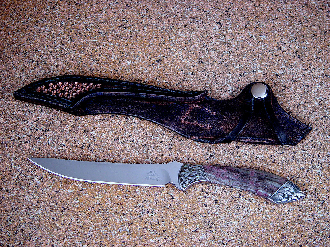 "Tusas" obverse side view in 440C high chromium stainless steel blade, hand-engraved carbon steel bolsters, Ruby in Zoisite gemstone handle, hand-tooled, bronze-washed leather sheath