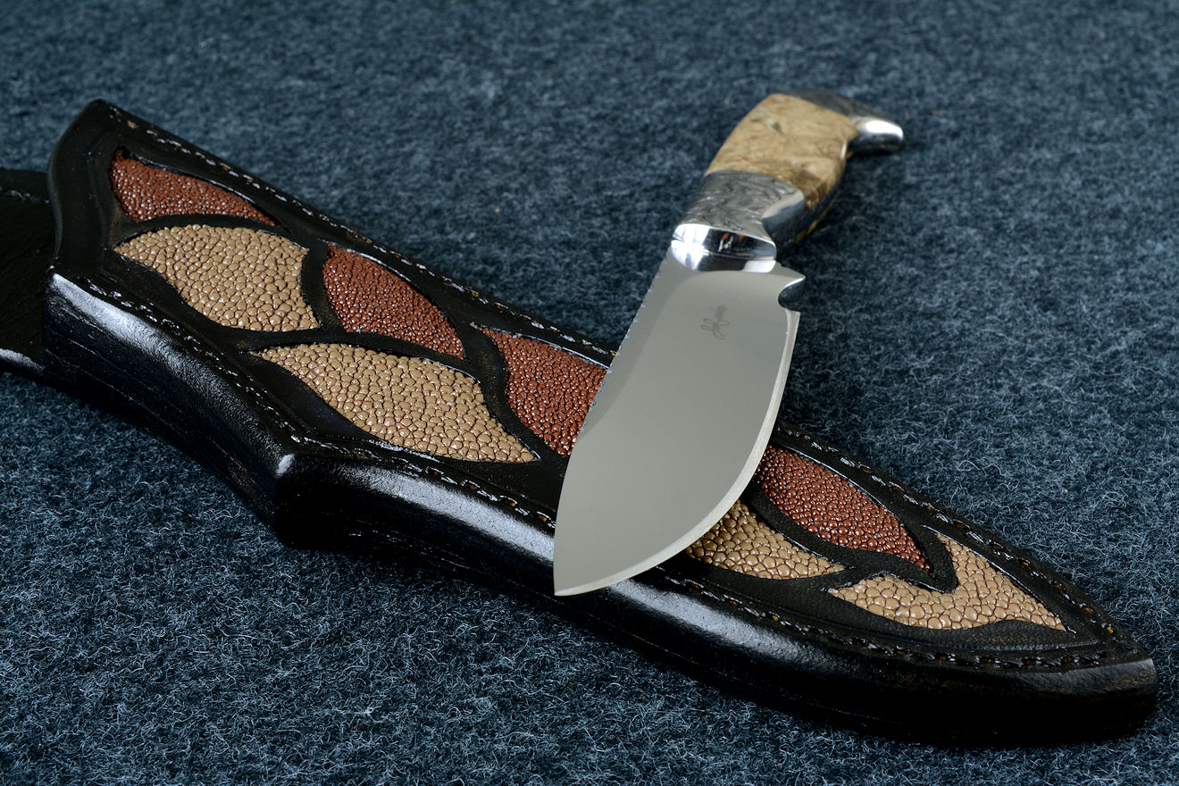 "Vulpecula" obverse side view in D2 extremely high carbon die steel blade, hand-engraved 304 stainless steel bolsters, Petrified Fern fossil gemstone handle, hand-carved leather sheath inlaid with rayskin
