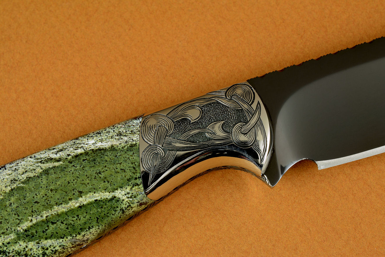 "Vulpecula" obverse side view in hot-blued O1 high carbon tungsten vanadium tool steel alloy, hand-engraved 304 stainless steel bolsters, Silver Leaf Serpentine gemstone handle, Frog skin inlaid in hand-carved leather sheath
