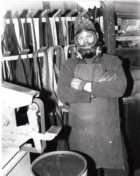 The Knife Maker in full safety gear in his element: steel, dust, abrasives