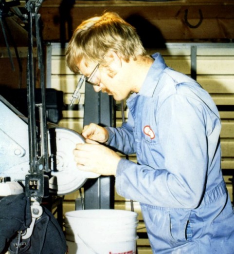 In my early 20's, grinding a blade. Safety gear removed for the picture, look at those clean coveralls and clean quench bucket!