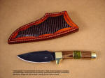 "Alamogordo" Obverse side view: O-1 high carbon tungsten-vanadium alloy tool steel blade, bead blasted and hot blued, brass guard, pommel, and fittings, zebrawood hardwood and serpentine gemstone handle, lizard skin inlaid in hand-carved leather sheath
