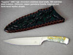 "Cygnus" handmade knife in high chromium stainless tool steel hollow ground blade, 304 stainless steel bolsters, orbicular jasper gemstone handle, and hand-carved leather sheath, laced