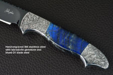 "Carina" obverse side view in mirror polished and hot-blued O1 high carbon tungsten-vanadium tool steel blade, hand-engraved 304 stainless steel bolsters, Labradorite gemstone handle, hand-carved, hand-dyed leather sheath