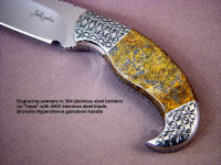 Iraca: fine handmade knife by Jay Fisher, obverse side view: 440C high chromium stainless steel blade, hand-engraved 304 stainless steel bolsters, Bronzite Hypersthene gemstone handle, Frog skin inlaid in hand-carved leather sheath