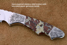 "Thuban" obverse side bolster engraving detail in CPM154CM powder metal technology high molybdenum stainless steel blade, hand-engraved 304 stainless steel bolsters, Brecciated Jasper gemstone handle, hand-carved leather sheath inlaid with rayskin