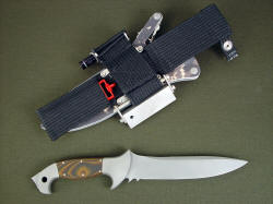 "Anzu" tactical combat knife, reverse side view. Sheath has ultimate belt loop extender and accessory package including sharpener, fire starter, and flashlight