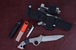 "Ari B'Lilah reverse side view, with sheath back and accessories: MagTac extreme LED high power tactical flashlight, DMT diamond abrasive sharpener, and Maglite Solitaire LED back-up flashlight with retainer