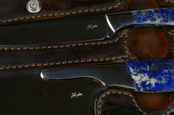 Enlargement of maker's mark in Concordia and Sanchez Custom Chef's Knives in T3 cryogenically treated 440C high chromium stainless steel blades, 304 stainless steel bolsters, Lapis Lazuli gemstone handles, book case in top grain leather, leather shoulder and belly, hand-carved, stainless steel snaps