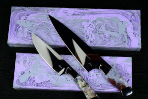 Corvus, CygnusST Chef's knives, maker's mark detail,  in CPM154CM powder metal technology and 440C high chromium martensitic stainless steel blades, T3 deep cryogenically treated, 304 stainless steel bolsters, Bay of Fundy Agate and Kaleidoscope stone gemstone handles, hand-cast, hand-dyed silicone prises
