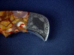 "Flamesteed" obverse side rear bolster engraving detail. 304 stainless steel is very difficult to engrave, making this a unique and highly durable work of art.