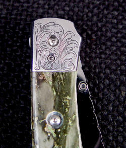"Gemini" liner lock folding knife engraved bolster detail, reverse side