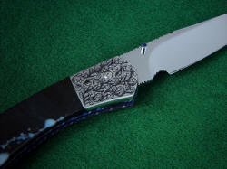 "Gemini" folding knife, reverse side front bolster detail. Hand-engraving on 304 stainless steel is rare due to its very hard and tough character, but the material is zero care and extremely high longevity.
