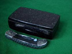 "Gemini" with eternal granite gemstone case in black Galaxy Granite. This photo shows the reflective polish on the granite sarcophagus. 