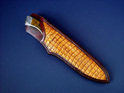 "Golden Eagle" sheathed view. Sheath has natural caiman skin inlays in hand-carved leather shoulder