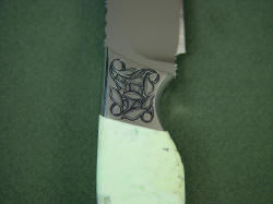 Izanami fine handmade knife, reverse side front bolster engraving detail. Nice design of overlapping leaves. 