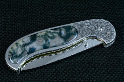 "Izar" linerlock folding knife, reverse side view, folded. Knife has thumb studs on both sides for easy opening in either hand