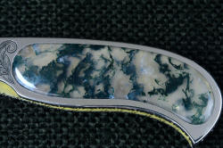 "Izar" linerlock folding knife, obverse side view, handle detail. Handle scales are polished, smooth, vitreous Indian green moss agate gemstone