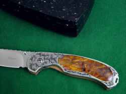 "Izar" liner lock folding knife with granite case. Anodized titanium lockplate matches color of gemstone