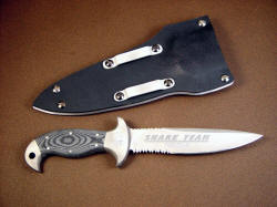 "Macha" PSD combat knife, reverse side view. Note belt clamps on kydex sheath, machine engraving on blade grind and bolsters