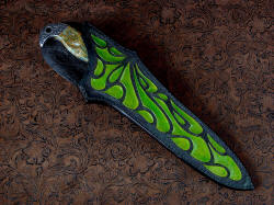 "Macha Navigator EL" sheathed view. Sheath is deep and protective, with high back for comfort. Design is hand-carved, hand-tooled, hand-dyed with sucessive color layers for unique appearance. All surfaces are sealed and polished. 