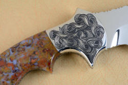 "Orion" Three power reverse side front bolster engraving detail. Rolling leaves in design compliment the curves of the blade and sheath inlay