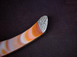 "Procyon" reverse side rear bolster detail. Light vine and tendril pattern of hand-enraving compliments the knife