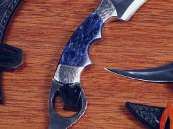 "Raptor" kerambits, case hanger close up. Hangers match engraving on bolsters, ice crystal form