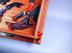 "Raptor" kerambits case hanger detail. Hangers for Manicouagan are hand-carved bloodwood, match case tension mortise wedges