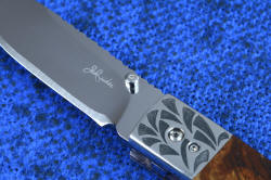 "Sadr" linerlock folding knife, maker's mark detail. 440C high chromium blade is cryogenically treated for optimum condition, hard, corrosion resistant, wear resistant, and tough