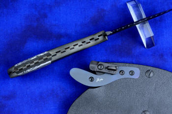 "Skeg"  tactical, counterterrorism, crossover knife, spine filework detail view in T4 Cryogenically treated ATS-34 high molybdenum martensitic stainless steel blade, 304 stainless steel bolsters, white and black tortoiseshell pattern G10 fiberglass/epoxy composite handle with black and gray Micarta phenolic spacers, hybrid tension tab-locking sheath in kydex, anodized aluminum, black oxide stainless steel and anodized titanium