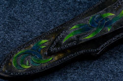 "Thuban" sheath back detail. This is a 3 power enlargement, showing carving on belt loop as well as sheath back. 