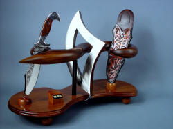 "Tribal" knife and stand art form in stainless steel, hardwoods, leather.