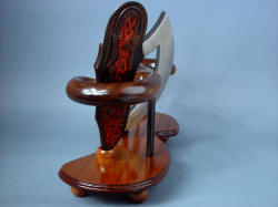 "Tribal" knife sculpture stand. Walnut wraps sheath body, set by base of turned mesquite hardwood