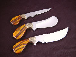 "Trophy Game Set" reverse side view. Trio of knives all have palm handles, nest in the palm comfortably with finger groove control