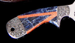 Sodalite and Italian Goldstone gemstone mosaic on full tang handmade knife with hand-engraving on carbon steel bolsters