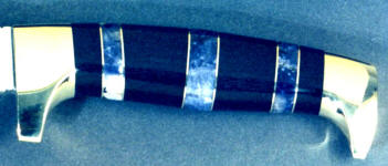 Scapolite gemstone in hidden tang custom knife handle with brass and ebony