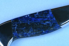 Sodalite, without bright reflector above knife, demonstrates truer color and density 