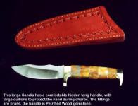 A large "Sandia" is actually a faceted Bowie blade design; this one has a petrified wood hidden tang handle