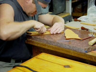 Hand-carving knife sheaths with a scalpel for inlay work. This is long, difficult, meticulous hand work at very close range