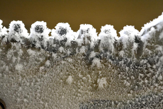 Ice crystals forming on knife blade as it warms to room temperature from deep cryogenics