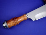 Peach tree wood turned handle on "Andrimne" fine chef's master knife. Wood is beautiful and very durable.